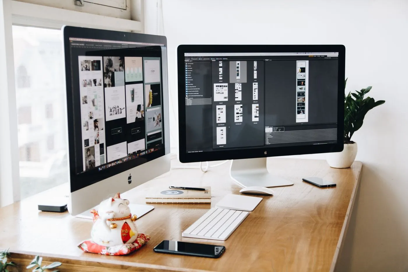 Designer reviewing an ecommerce mobile storefront mockup on dual monitors