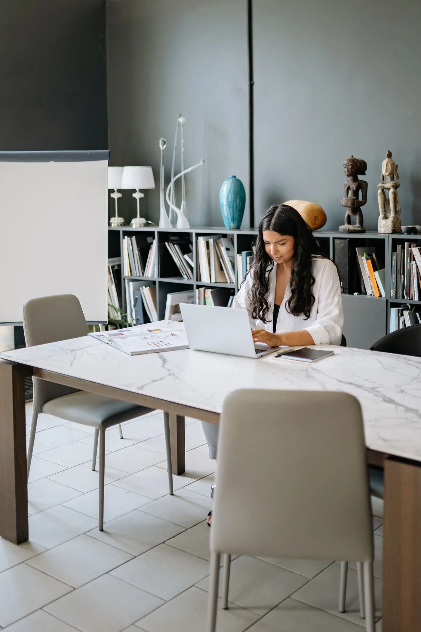 Marketer focused on laptop campaign work in a modern office