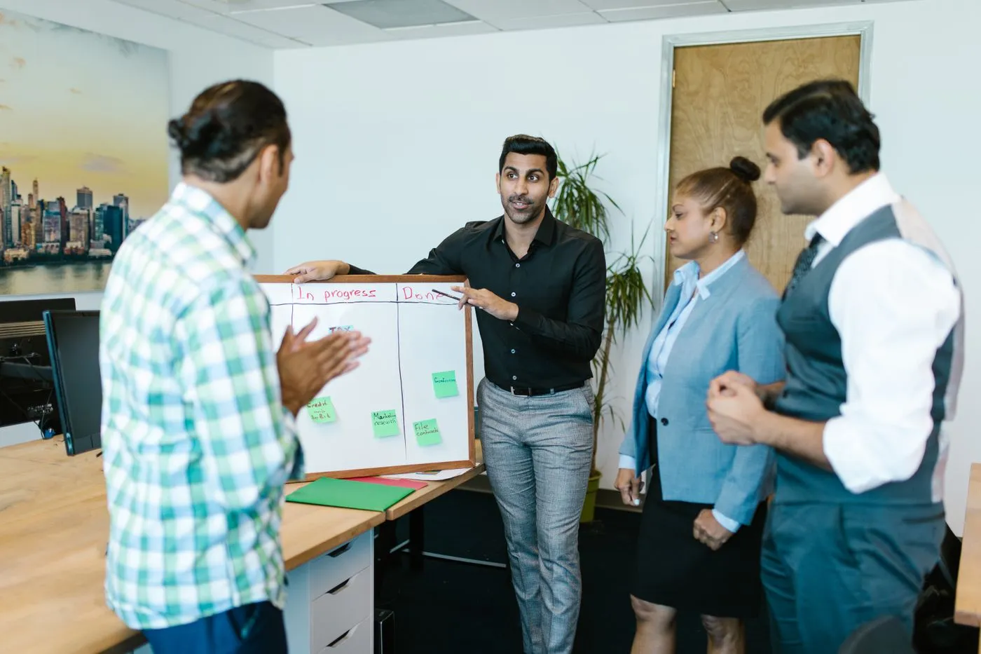 Growth team reviewing market research and execution priorities on a whiteboard